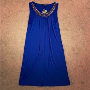 Dress with neckline embellishment